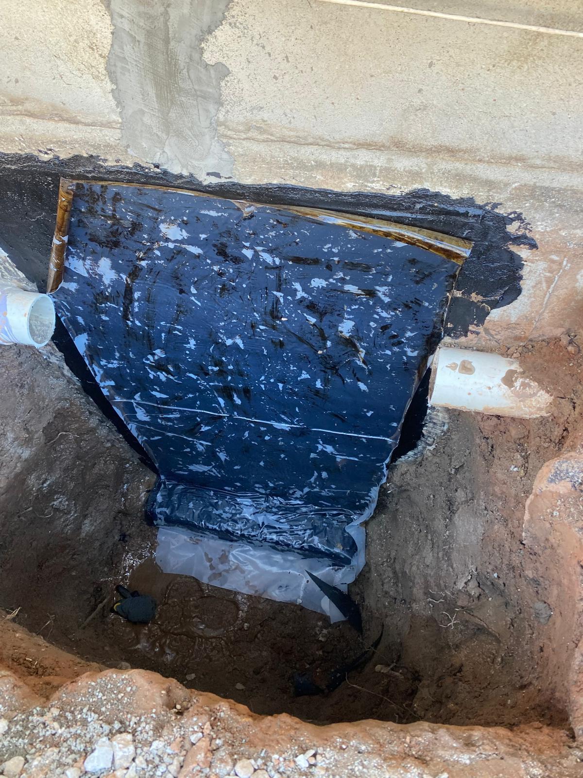 Waterproofed foundation section before backfill